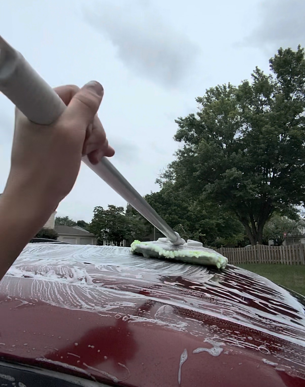 Hand wash mitt pass on a red sedan